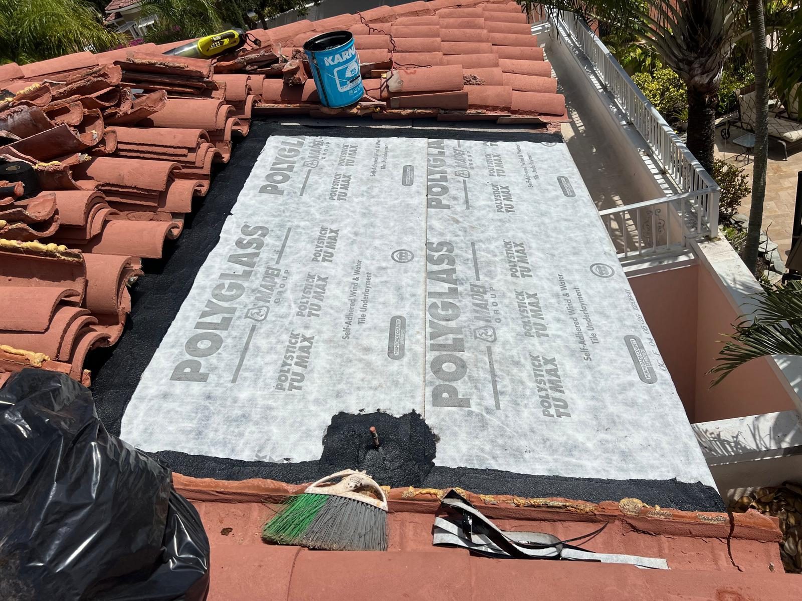 Self-adhered Polyglass tile underlayment installed on a terracotta tile roof