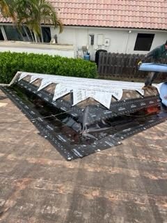 Peel-and-stick roofing membrane installed along a roof hip